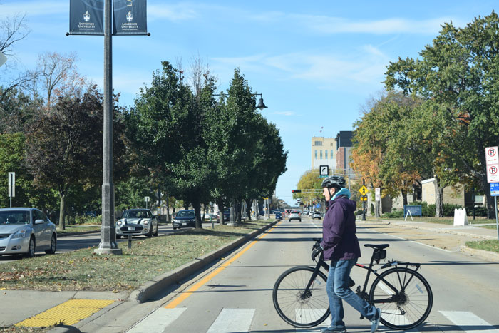 Biker crossing street downtown